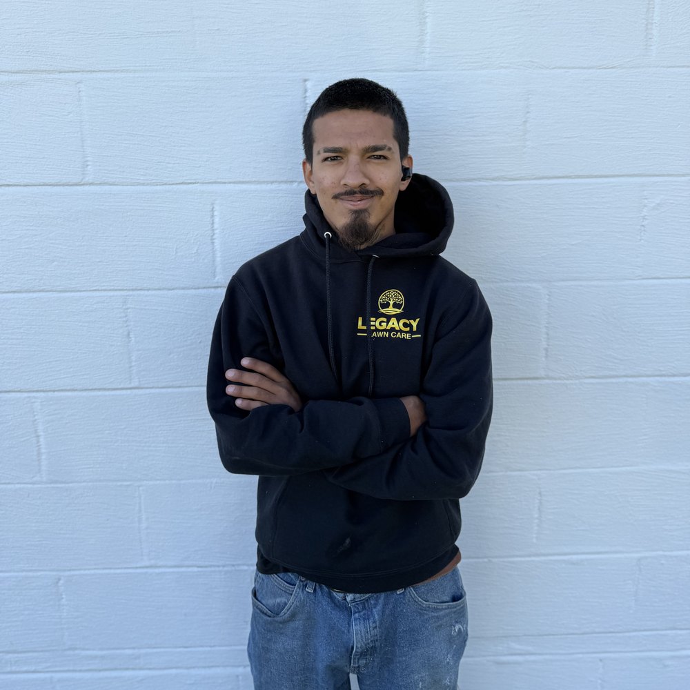 Legacy Lawn Care crew member in uniform
